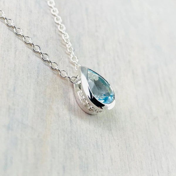 Delicate Teardrop Blue Topaz and Silver Pendant with CZ.