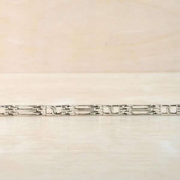 Silver bracelet on a light beige background