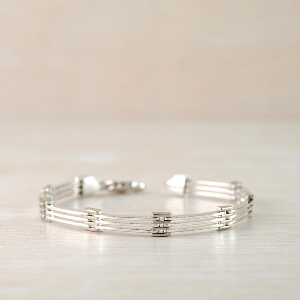 As the name suggests the design originates  form interlocking chain style panels that look a little like barred gates - in this case 8 links with 3 bars interlinked along the length of the bracelet. The section where they interlink acts not only a a hinge but as a decorative feature.