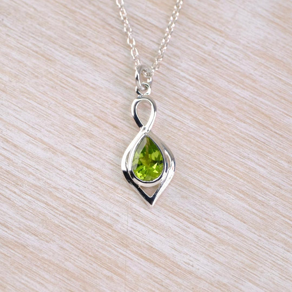 Silver pendant with a green gemstone on a 
silver chain