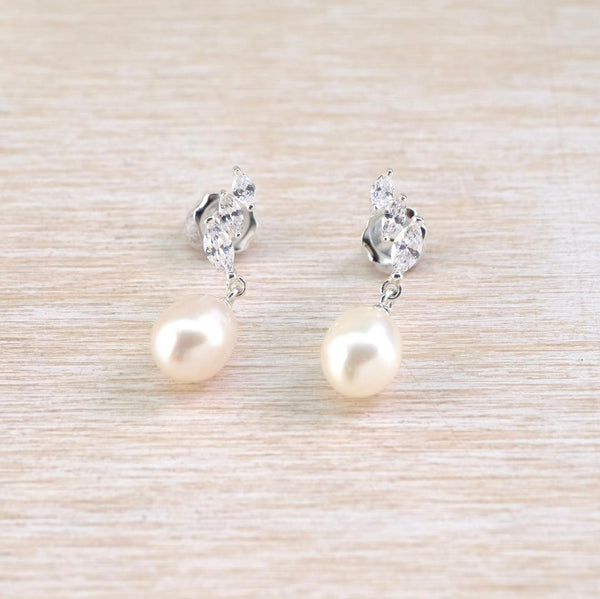 Pearl  drop earrings with silver  and sparkly cz stud fitting.