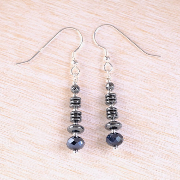 Pair of silver earrings with black beads.