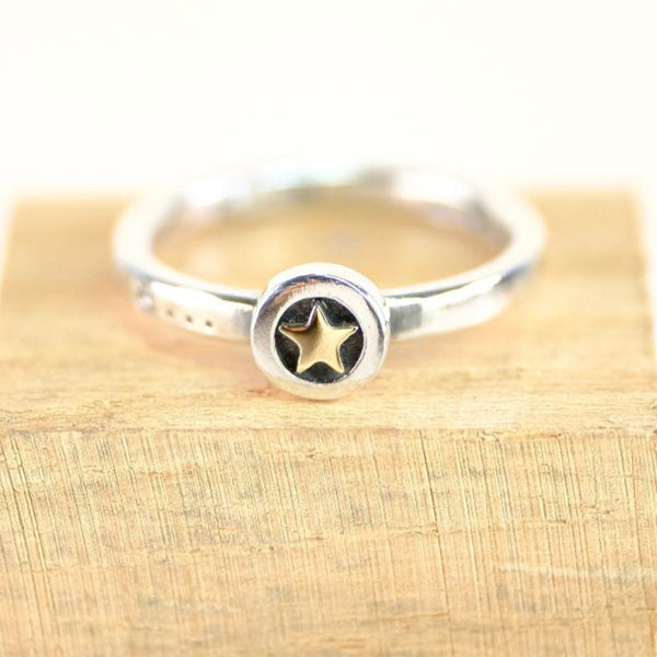 silver ring with gold star at centre