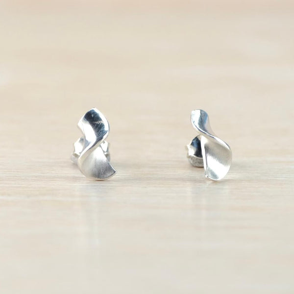 silver stud earrngs with a twist design and satin finish