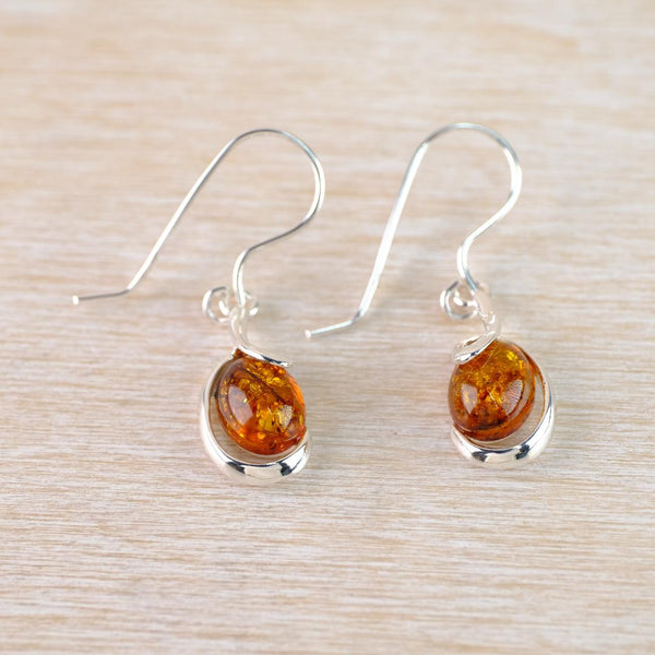 Sterling Silver and Oval Amber Drop Earrings with Swirl Overlay.