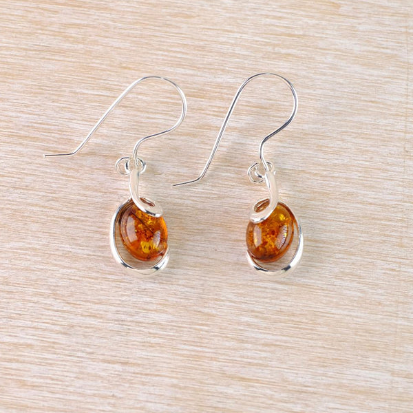Sterling Silver and Oval Amber Drop Earrings with Swirl Overlay.