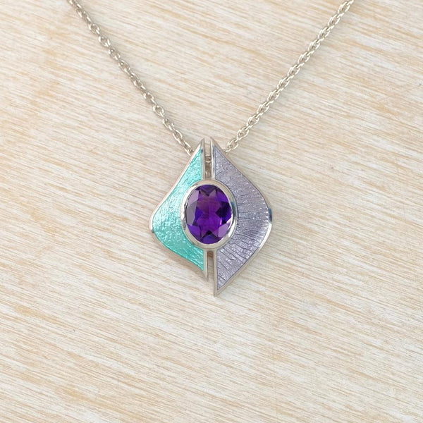 an enamel pendant in lilac and turquoise set wih an amethyst