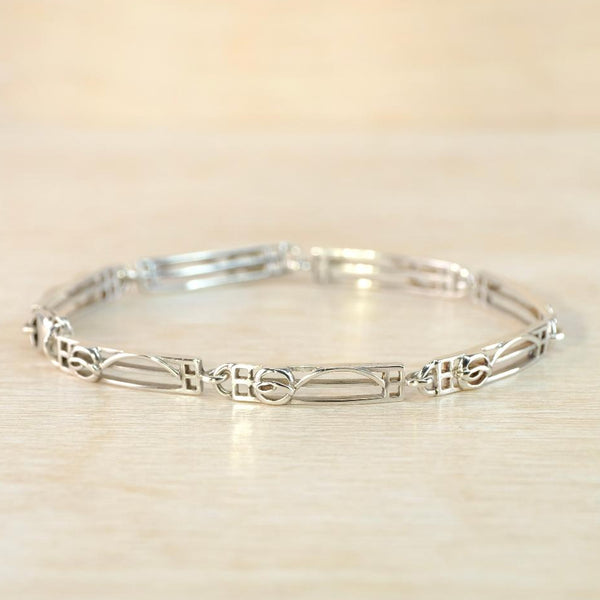 Silver bracelet on a light wooden surface