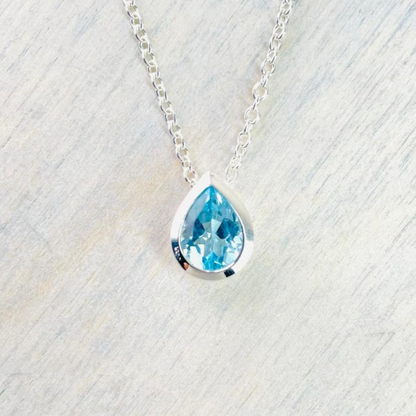 Delicate Teardrop Blue Topaz and Silver Pendant with CZ.