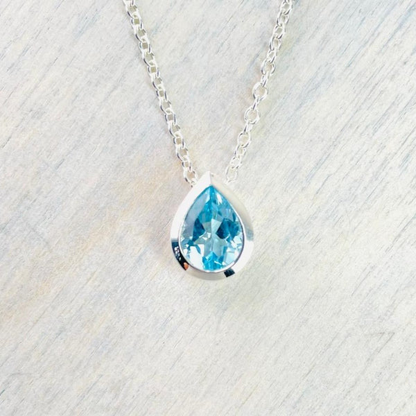 Delicate Teardrop Blue Topaz and Silver Pendant with CZ.