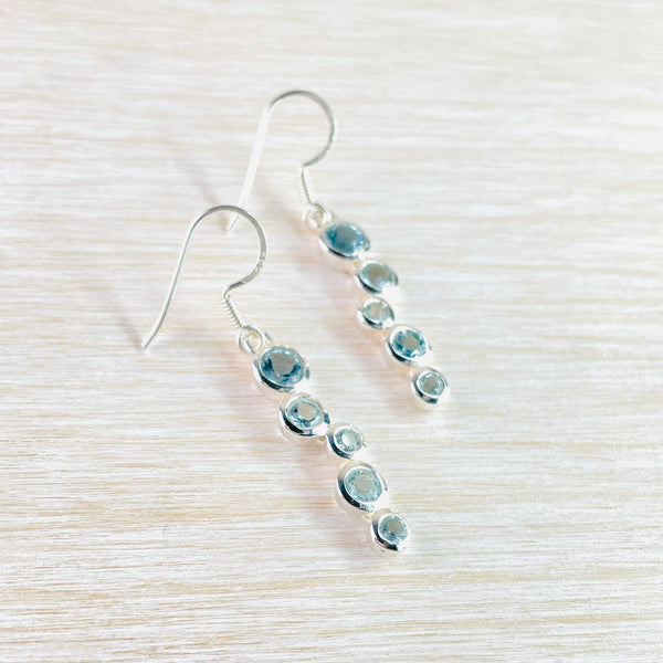 Sterling Silver Staggered Drop Faceted Blue Topaz Earrings.