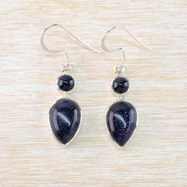 The stones are very dark blue with sparkly flecks - like stars ina a night sky. Each earring has two stones, a smaller round one on the top and a larger pear shaped one on the bottom. Connected by a short silver rod and hanging off a silver hook.