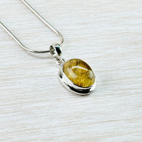 Oval Sterling Silver and Golden Rutilated Quartz Pendant.