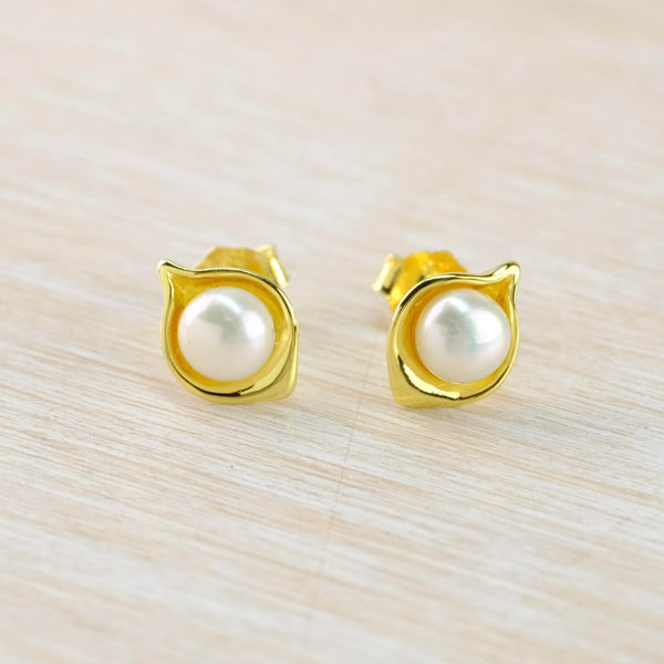 Round white pearl nestles in the middle of a little gold pod.