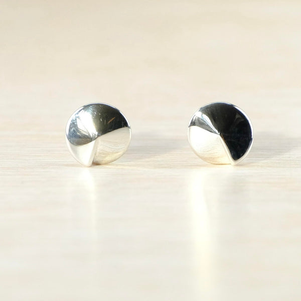 Highly polished silver, round shaped earrings. They come to a gentle point in the centre to look like a dome.