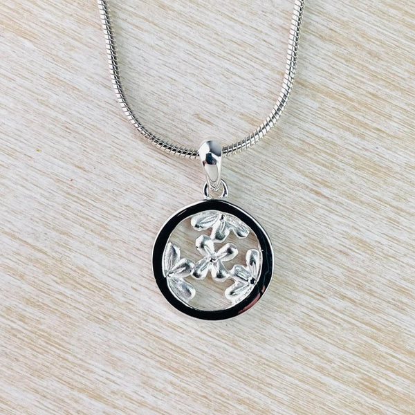 Sterling Silver Flowers in Circle Pendant by JB Designs.