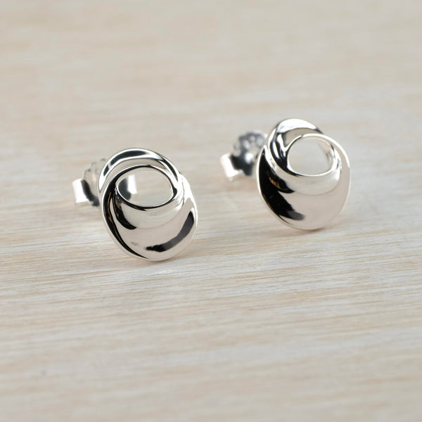 Very shiny oval earrings with a gentle twist and an oval opening in the top half.