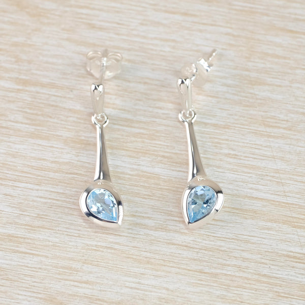 Pear Shaped Blue Topaz and Silver Drop Earrings by JB Designs.