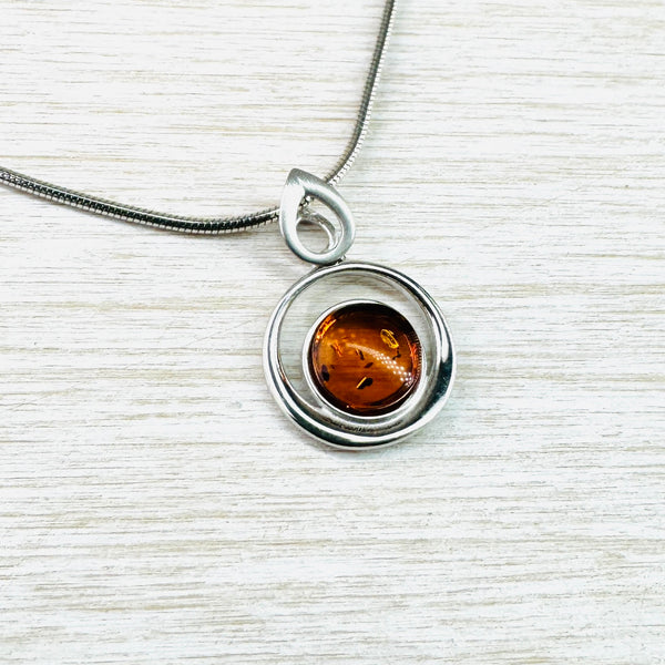 Contemporary Circular Amber and Sterling Silver Pendant.