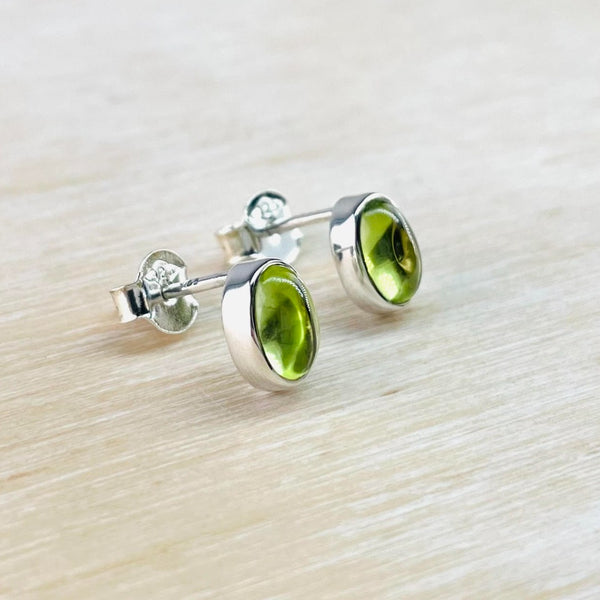 Oval bright green peridot stones very simply framed in silver