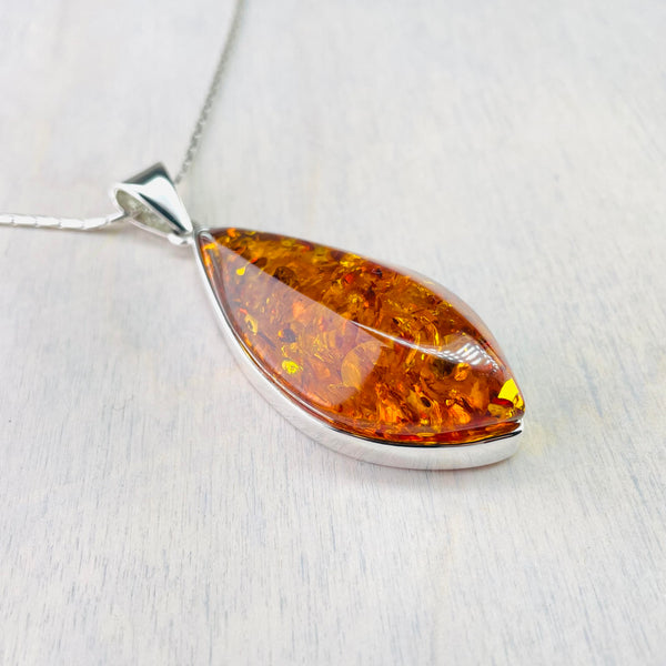 Large Diamond Shaped Amber and Silver Pendant.