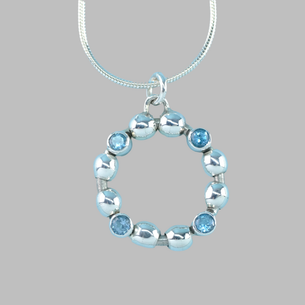 High Polished Sterling Silver and Blue Topaz Open Circle Pendant.