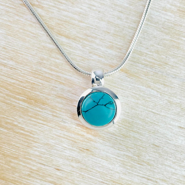 Small Round Sterling Silver and Turquoise Pendant.