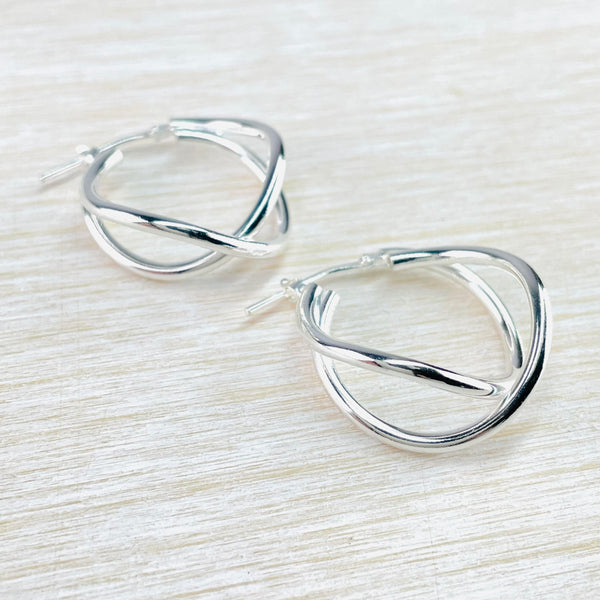 Sterling Silver Crossover Hoop Earrings by JB Designs.