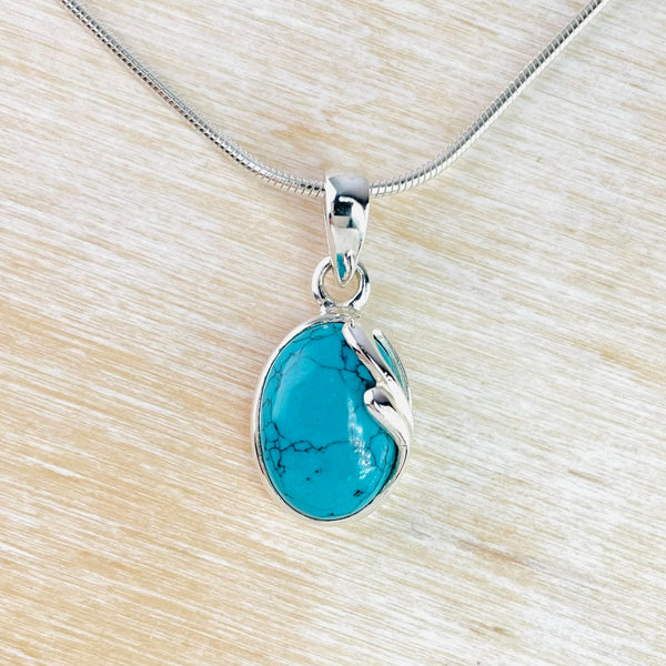 Oval Turquoise Pendant with Delicate Sterling Silver Overlay.