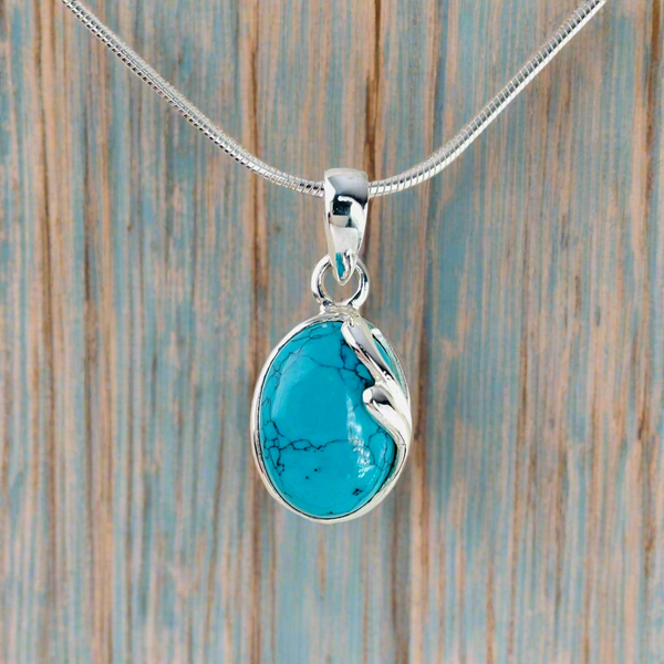 Oval Turquoise Pendant with Delicate Sterling Silver Overlay.