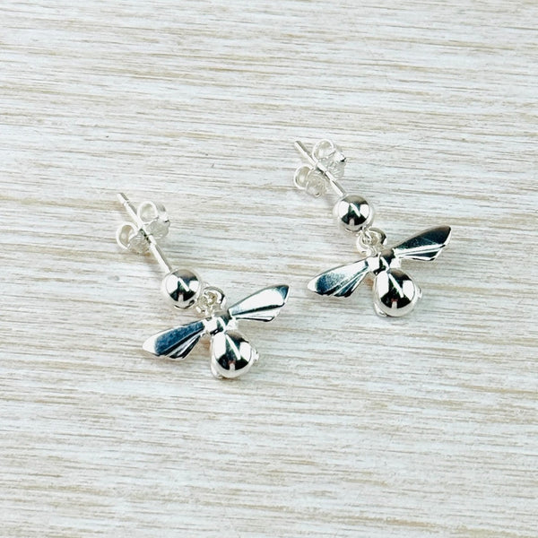 Plain shiny silver bees, with open wings. Attached to a silver ball, stem and butterfly fitting.