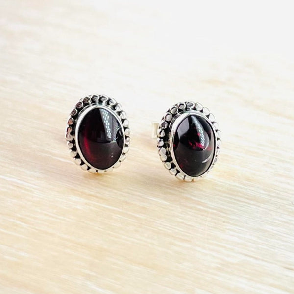 Oval Sterling Silver and Garnet Stud Earrings.