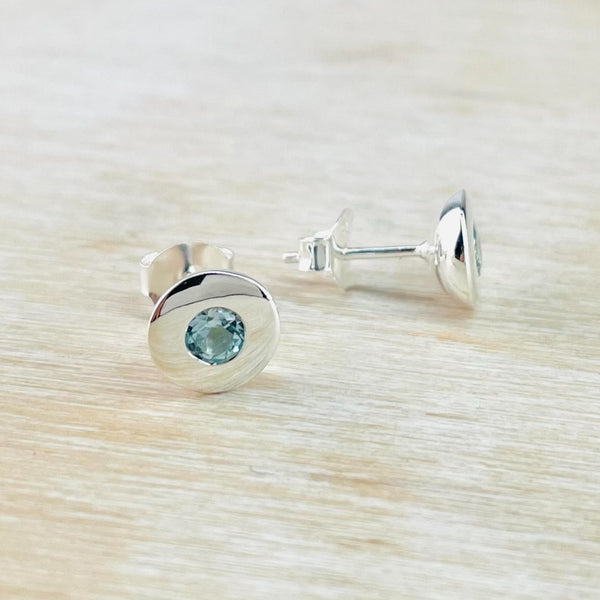 Round Sterling Silver and Blue Topaz Earrings.