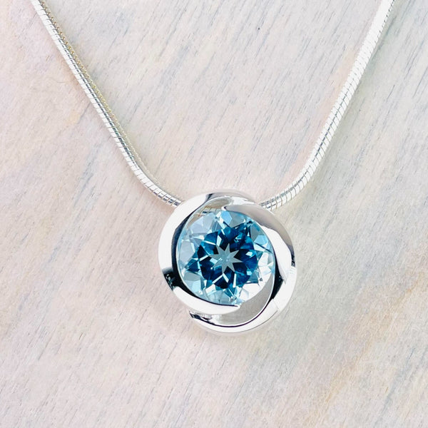 High Polished Silver and Circular Blue Topaz Pendant.