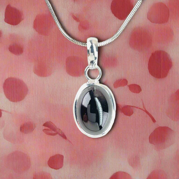 Oval Sterling Silver and Cabochon Garnet Pendant.