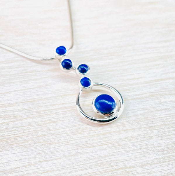 Sterling Silver and Staggered Lapis Lazuli Pendant with Hoop Setting.