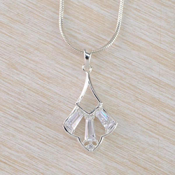 A fan shaped pendant with a real Deco feel. The bottom of the fan has three sparkly rectangular Cz stones set into it with see through gaps between them. The top half of the fan is a cut out  silver  teardrop shape. The pendant hangs from a silver snake style chain.