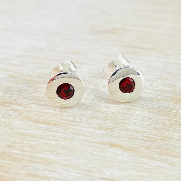 Round Sterling Silver and Garnet Stud Earrings.