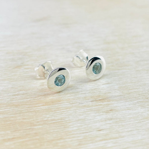 Round Sterling Silver and Blue Topaz Earrings.