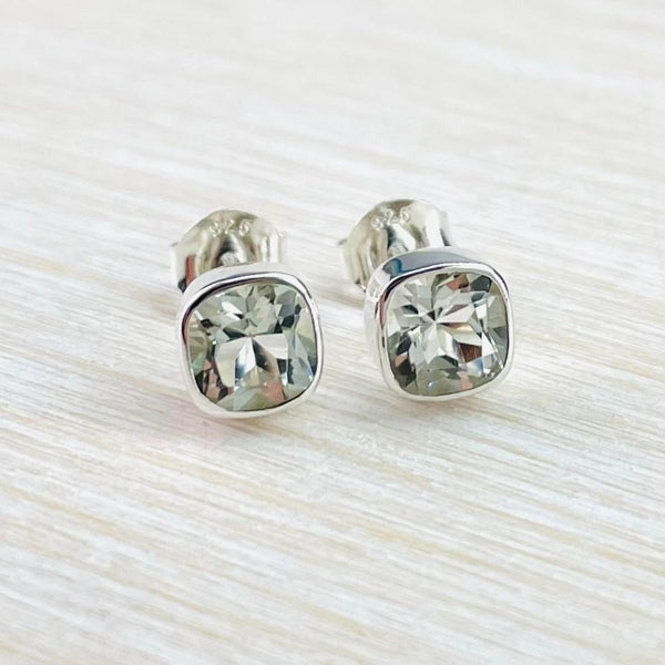 Cool pale green amethyst stones, in a rounded corner square shape are set in a silver surround. The stones have been faceted so are sparkly.
