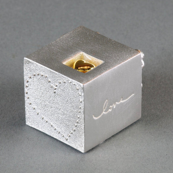 A Solid Pewter 'Love' Cube
