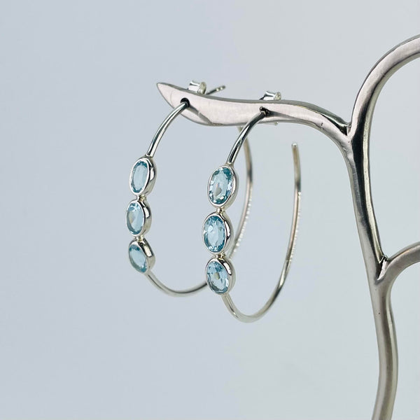 Round Hoop Silver and Blue Topaz Earrings.