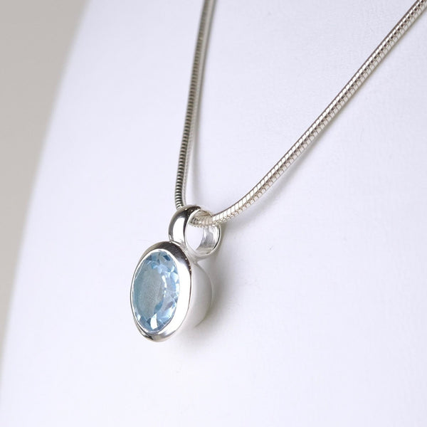 Small Round Blue Topaz and Silver Pendant.