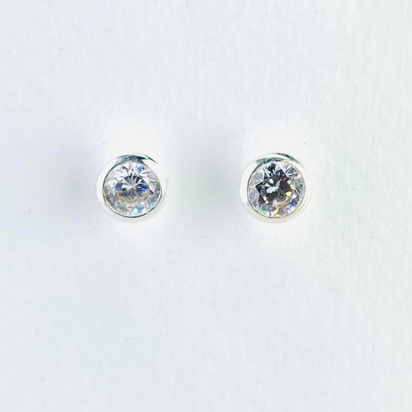Sparkly round Cz stones simply set in a round silver surround. From the front they appear flat, but the side view reveals they have a conical shape.
