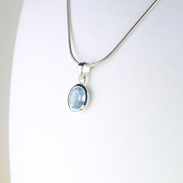 Simple Oval Blue Topaz and Silver Pendant.