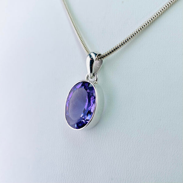 Oval Sterling Silver and Faceted Amethyst Pendant.