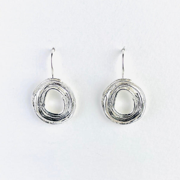 silver spiral earrings that are like rolled up silver, face on, with a solid hook.