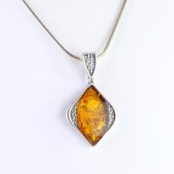 Amber and Patterned Silver Pendant.