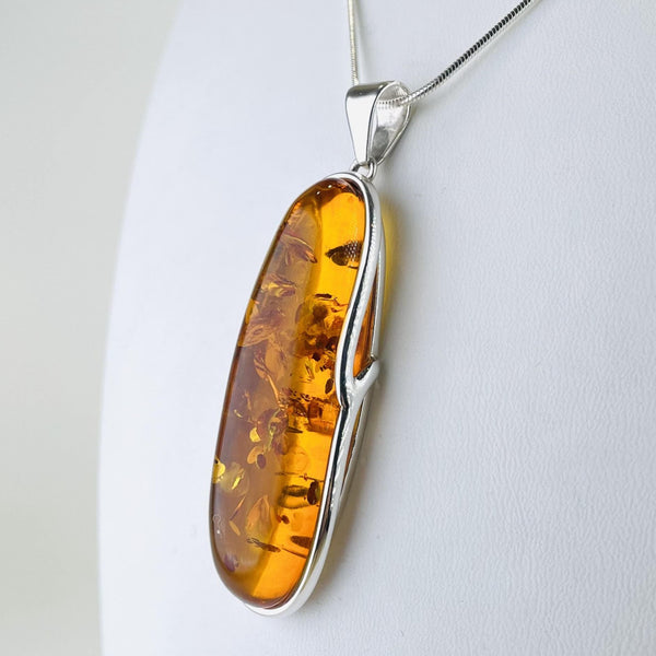 Long, Slender Amber and Silver Pendant.
