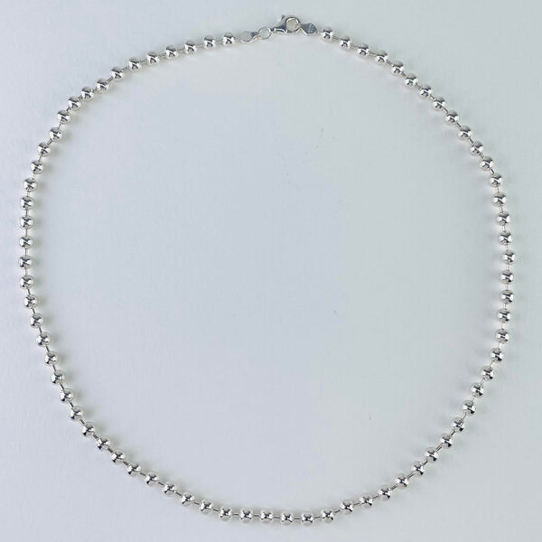 Plain polished sterling silver ball chain. it is formed of silver balls alternating with fine silver rods all the way around the length. it is finished with a lobster catch.